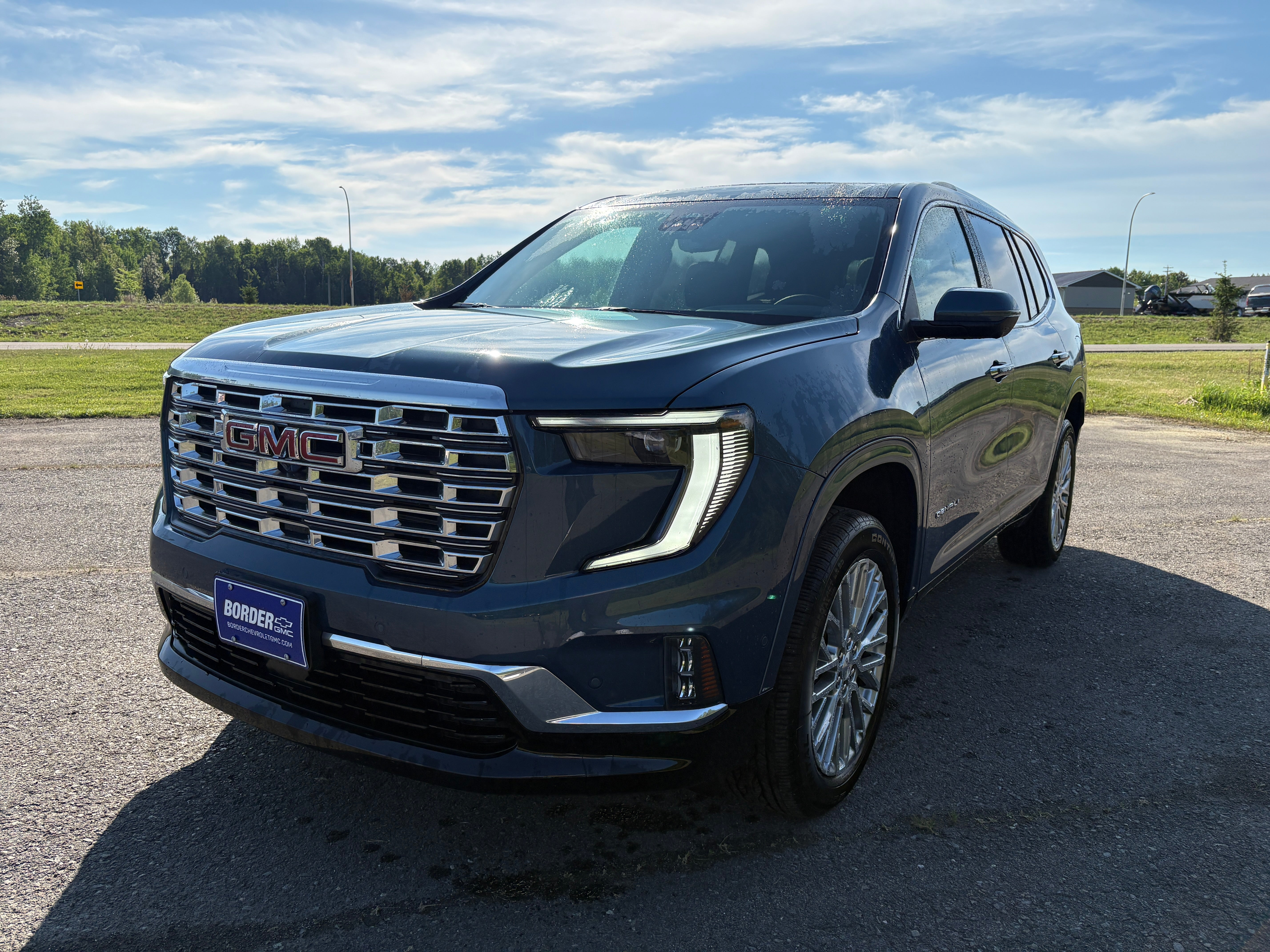 2026 GMC Acadia Denali in Downpour Metallic — front three-quarter view