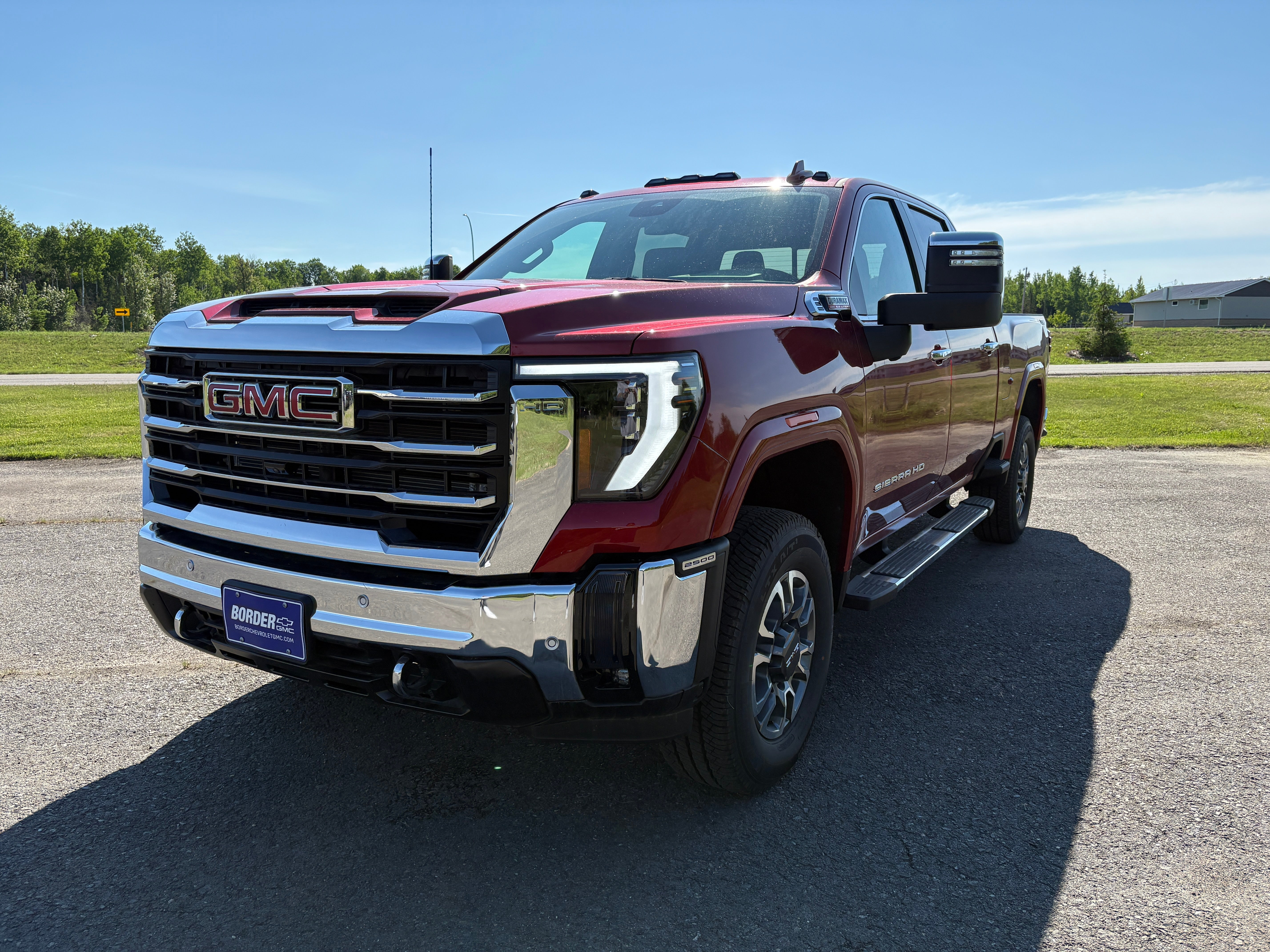 2025 GMC Sierra 2500 HD SLT in Volcanic Red Tintcoat — front three-quarter view